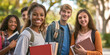 © AnNew - Diverse group of students with books standing outdoors, smiling