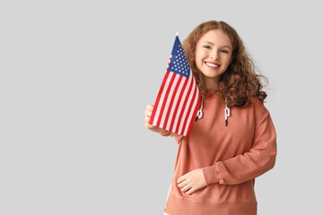 Poster - Young woman with USA flag on grey background