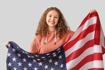 Poster - Young woman with USA flag on grey background