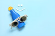 © Pixel-Shot - Drawings of smile made with sunscreen cream and sunglasses on blue background