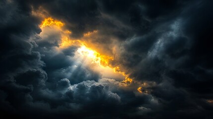 A dark cloudy sky with the sun shining through the clouds