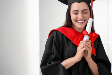 Wall Mural - Female graduate student with diploma in hall