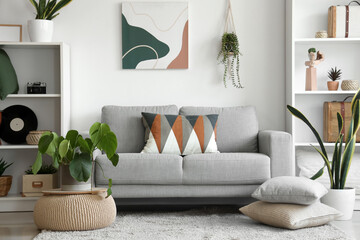 Poster - Stylish grey sofa with soft cushions in interior of modern living room