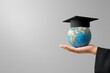 © VIK - Graduation cap with Earth globe. Business study abroad. Foreign education. Back to school. Study abroad business at universities around the world. Language study.