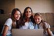 © StarDweller/peopleimages.com - Woman, children and laptop in living room for streaming, e learning and bonding as family. People, happiness and internet tech for education, development and homework as mother and daughter in home