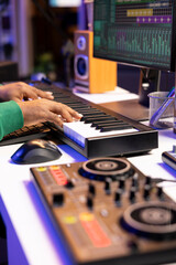 Leinwandbilder - Sound designer recording his electronic piano notes in home studio, plays midi controller song and adds effects on recordings before launching music. Artist uses synthesizer and amplifier. Close up.