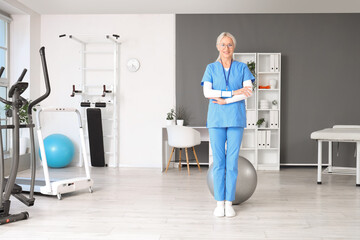 Canvas Print - Portrait of female physiotherapist in rehabilitation center