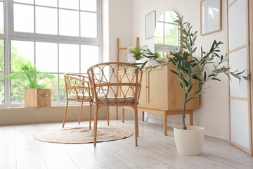 Sticker - Wicker chairs and wooden chest of drawers in interior of modern bathroom