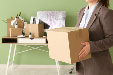 Wall Mural - Businesswoman with cardboard box in office on moving day, closeup