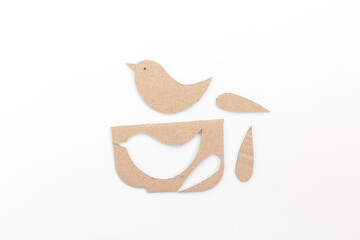 Wall Mural - a paper birds sitting on top of a table, cut out of cardboard, 