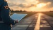 © Nawarit - Pilot in uniform, holding a flight plan on an airstrip, professional style, neutral tones, wide shot, soft lighting