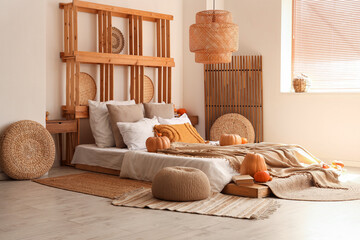 Wall Mural - Interior of cozy bedroom with autumn decor and poufs