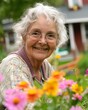 © DreamFrame - An old woman smiles happily while spending time in the flower garden.