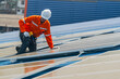 © ultramansk - Worker Technicians are working to construct solar panels system on roof. Installing solar photovoltaic panel system. Men technicians walking on roof structure to check photovoltaic solar modules.