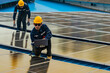 © ultramansk - engineer man inspects construction of solar cell panel or photovoltaic cell by electronic device. Industrial Renewable energy of green power. factory worker working on tower roof.