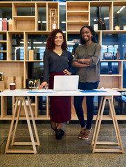 Wall Mural - Confident, portrait and women in startup with laptop, web design and business people for discussion. Arms crossed, meeting and intern planning with designer for website or advice at creative company