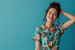 © Fotograf - A happy woman wearing a colorful floral shirt, smiling at the camera