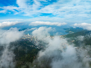 Aerial view of flowing fog waves on mountain tropical rainforest,Bird eye view image over the clouds Amazing nature background with clouds and mountain peaks in Thailand