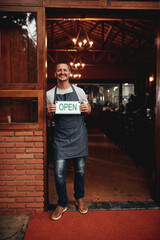 Poster - Entrance, portrait and man with open sign for restaurant, invite clients and welcome patrons for customer service. Brewery, owner and board with message for hospitality, doorway and small business