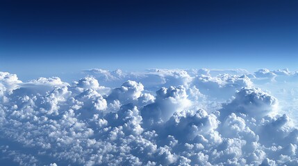 Sticker - An aerial view of a bright blue sky with puffy white clouds.