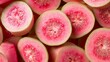 © arhendrix - Close-up of fresh, ripe guava fruit with pink flesh, showcasing the vibrant colors and juicy texture. Perfect for health and culinary visuals.