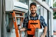© Fotograf - Worker holding a tool in a bright orange safety vest, ready for the job
