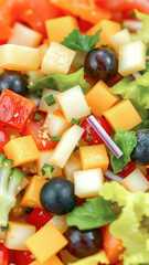 Close up of colorful salad with cheese, lettuce, and grapes