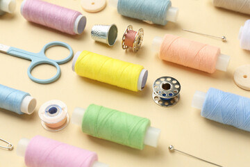 Poster - Different sewing supplies on beige background, closeup