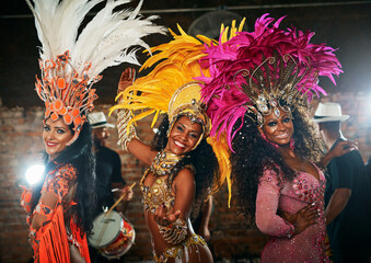 Wall Mural - Carnival, portrait and happy women with costume for dancing, celebration and expression of Brazilian culture. Festival, people or tradition with dancers for performance, creativity or energy at night