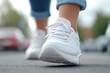 © Ari - Female ankle foot walking workout exercise on the road