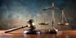 © Ole Studio - Powerful representation of the legal system with judicial gavel and scales of justice on a desk , courtroom, law