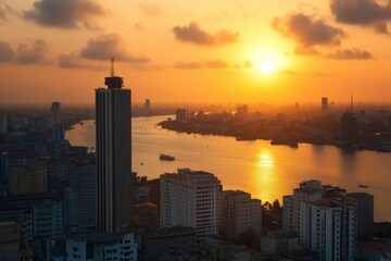 Canvas Print - Golden Sunset Over a Cityscape with a River and Skyscrapers