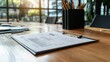 © Narongsag - Business Report on Clipboard on Wooden Desk with Window View