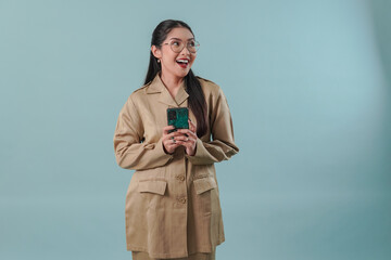 Wall Mural - Cheerful government worker woman holding smartphone while looking to the copy space beside her.