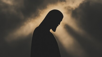 A minimalistic and powerful silhouette of Jesus Christ in profile, surrounded by rays of golden light breaking through clouds. 