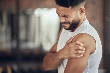 Wall Mural - Frustrated man, fitness and arm injury with muscle tension from pain, accident or inflammation at gym. Male person with sore shoulder, joint or sprain in discomfort from workout or indoor exercise