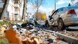 © Lens Legacy - Silver sedan involved in a severe car accident on a city street, surrounded by debris and fallen leaves, indicating the impact and the aftermath of the collision.