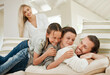 © peopleimages.com - Home, happy children and family pile with father on sofa for love, care or bonding together in lounge. Smile, kids and parents stack on couch with mother, down siblings play or lying for support