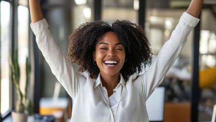 portrait of black businesswoman is celebrating her success in the office, feeling happy 