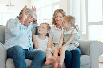 Canvas Print - Bunny ears, smile or visit with grandparents and children on sofa in living room of home together. Having fun, laughing or joking with senior man, woman and sister girls in apartment for comedy