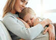 © KayJoint/peopleimages.com - Mother, girl and hug for comfort in home, console child and support or care for sad kid on couch. Mama, daughter and embrace for security in relationship, family bonding and empathy or compassion