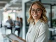 © Karaket - Smiling confident businesswoman with colleagues in boardroom