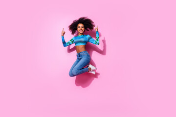 Wall Mural - Full body photo of attractive young woman jump point up empty space dressed stylish blue clothes isolated on pink color background