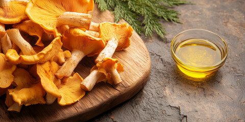 Wall Mural - Whole chanterelles scattered on a wooden board next to a small dish of oil