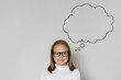 © millaf - Clever child girl with thought cloud bubble above head thinking on white background