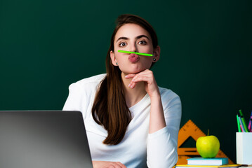 Portrait of funny funky school girl want rest relax make break pause fool grimace pencil between nose lips. Crazy student having fun in classroom concept. Funny face of student or school girl.