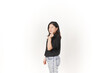 © Sino Images Studio - Young Asian woman Showing korean love finger wearing Black t-shirt and jeans isolated on white background