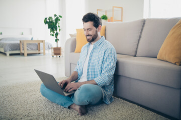 Wall Mural - Photo of handsome bearded alone mature age adult man freelancer working from home remote specialist programming indoors using laptop