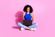 © deagreez - Photo of girl sit floor using netbook writing message isolated pastel color background