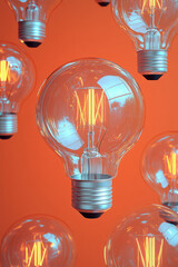 Poster - Fragmented eco-friendly light bulbs scattered across a pastel orange surface,